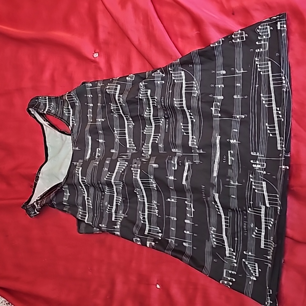 Brand new tank top with music notes and has a Racer back.